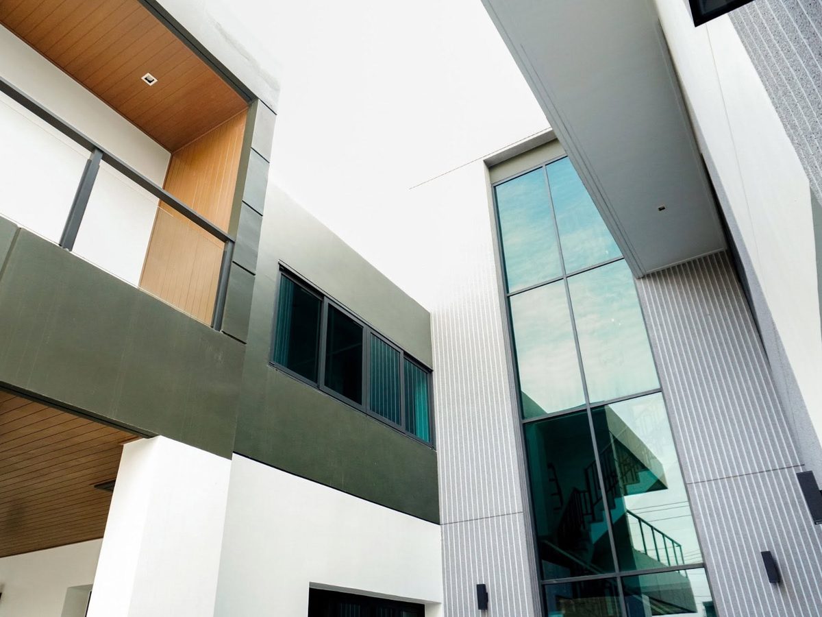 Modern office building with tall glass walls and window film