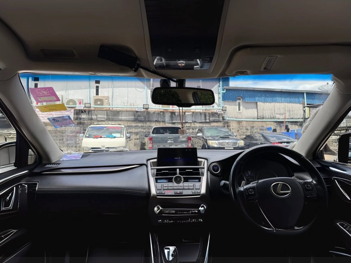 Driver's-eye view through the tinted windshield of a luxury car, clear and not dark